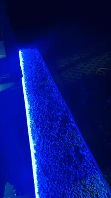 a strip of blue rocks in the water at night at Свети Йоан in Sozopol