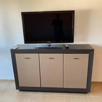 a flat screen tv sitting on top of a cabinet at The modern apartment in the ancient city in Sozopol