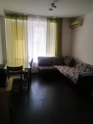 a living room with a couch and a bed at Хаджи Иванов in Varna City
