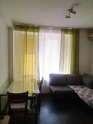 a living room with a couch and a glass table at Хаджи Иванов in Varna City