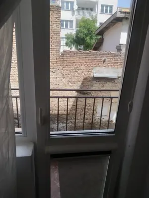 a door to a balcony with a view of a brick wall at Хаджи Иванов in Varna City