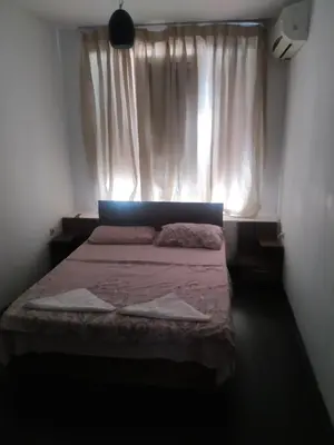 a small bedroom with a bed with a window at Хаджи Иванов in Varna City