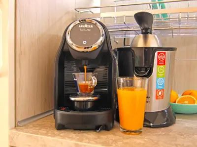 a coffee maker and a glass of orange juice at Premium Apartment Villa Aristo in Sveti Vlas