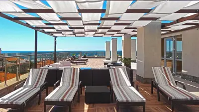 a patio with chairs and a table on a balcony at Premium Apartment Villa Aristo in Sveti Vlas