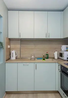 a white kitchen with white cabinets and appliances at The Blue Apartment - 1BD with a Cozy Balcony by Flat Mаnager in Varna City