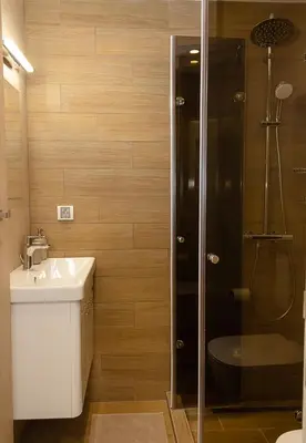 a bathroom with a shower and a sink and a toilet at The Blue Apartment - 1BD with a Cozy Balcony by Flat Mаnager in Varna City