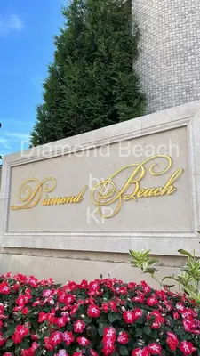 a sign for the front of a building with flowers at Diamond Beach Sarafovo by KP - Luxury Collection, Apt 5 in Burgas City