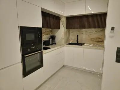 a kitchen with white cabinets and a black microwave at Diamond Beach Sarafovo by KP - Luxury Collection, Apt 5 in Burgas City
