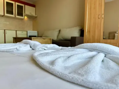 a bed with white towels on top of it at Privilege Fort Beach - Menada Apartments in Elenite