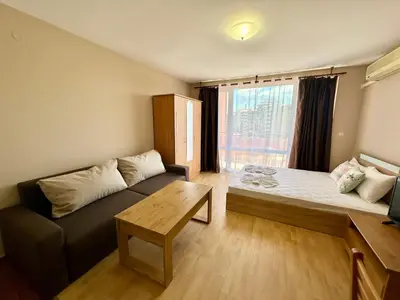 a living room with a couch and a table at Privilege Fort Beach - Menada Apartments in Elenite