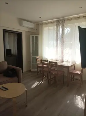 a living room with a dining room table and chairs at Apartment Starfish in Varna City