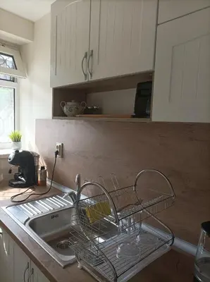 a dish rack sitting next to a sink in a kitchen at Apartment Starfish in Varna City