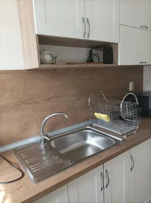 a kitchen sink with a dish drying rack next to it at Apartment Starfish in Varna City