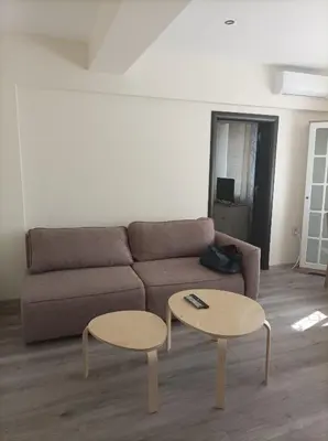 a living room with a couch and two tables at Apartment Starfish in Varna City