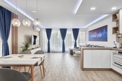 a living room with a kitchen and a dining room at Miami Vibe by EstateAutomata in Burgas City