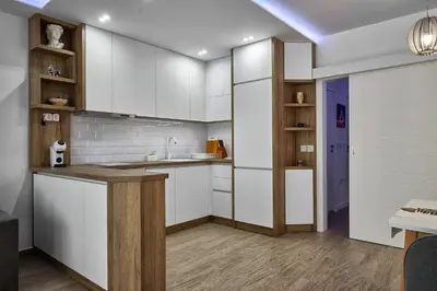 a kitchen with white cabinets and a counter top at Miami Vibe by EstateAutomata in Burgas City