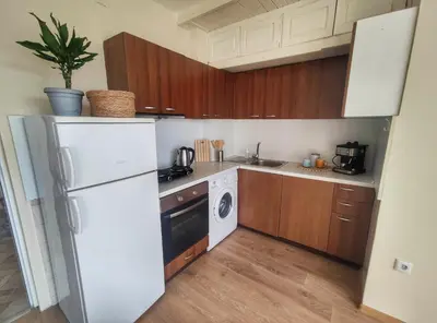 a kitchen with a white refrigerator and a dishwasher at By The Cathedral, 1 bed flat in Varna City