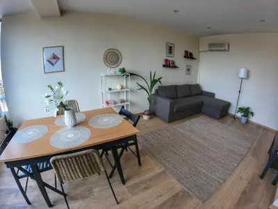 a living room with a table and a couch at By The Cathedral, 1 bed flat in Varna City