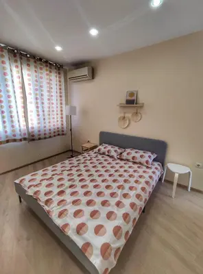 a bedroom with a large bed and a window at By The Cathedral, 1 bed flat in Varna City