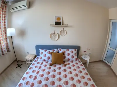 a bedroom with a bed with pink and white polka dots at By The Cathedral, 1 bed flat in Varna City