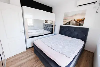 a bedroom with a bed and a large mirror at LifeStyle 6 in Sunny Beach