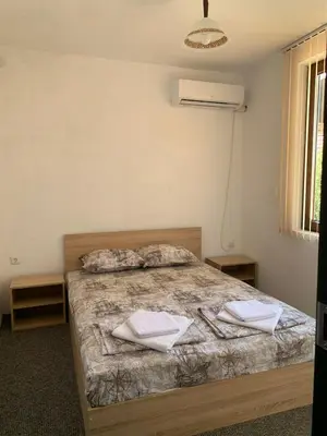 a bedroom with a bed with two towels on it at Sozopol Old Town - Guest House Fenix in Sozopol