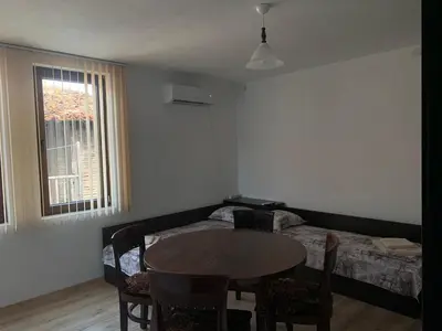 a living room with a table and a bed at Sozopol Old Town - Guest House Fenix in Sozopol