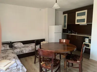 a kitchen with a table and chairs in a room at Sozopol Old Town - Guest House Fenix in Sozopol