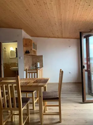 a dining room with a wooden table and chairs at Sozopol Old Town - Guest House Fenix in Sozopol
