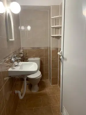 a bathroom with a white toilet and a sink at Sozopol Old Town - Guest House Fenix in Sozopol