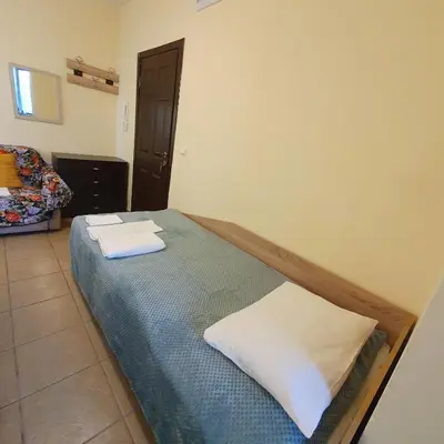 a bedroom with a bed with two towels on it at Viriks in Burgas City