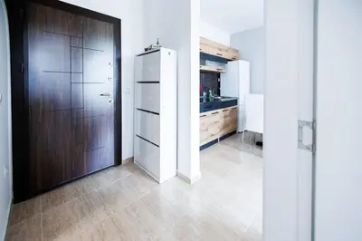 a kitchen with a refrigerator and a wooden door at LifeStyle 6 in Sunny Beach