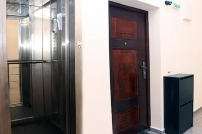 a wooden door in a room next to a refrigerator at Shik & Chic in the Heart of Burgas # 5min from beach in Burgas City