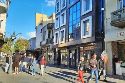 a group of people walking down a city street at Shik & Chic in the Heart of Burgas # 5min from beach in Burgas City