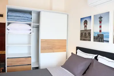 a bedroom with a bed and a built in closet at Shik & Chic in the Heart of Burgas # 5min from beach in Burgas City