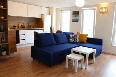 a living room with a blue couch and a table at Shik & Chic in the Heart of Burgas # 5min from beach in Burgas City
