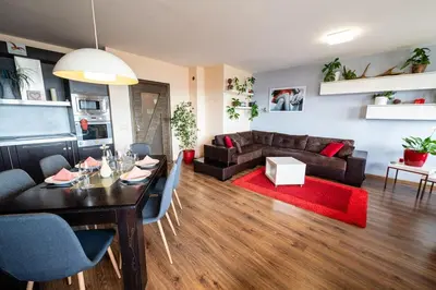 a living room with a dining table and a couch at При Галя / Прекрасен апартамент в тих квартал in Varna City