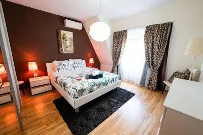 a bedroom with a bed and a large window at При Галя / Прекрасен апартамент в тих квартал in Varna City