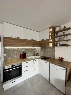 a kitchen with white cabinets and a sink at Central Cosy, Fully Renovated 2BD Near the Cathedral in Varna City