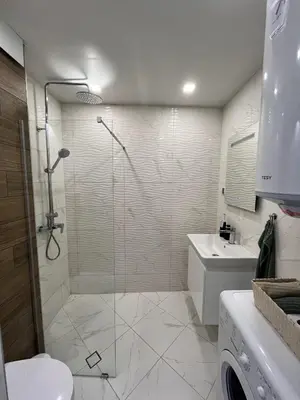 a bathroom with a shower and a toilet and a sink at Central Cosy, Fully Renovated 2BD Near the Cathedral in Varna City