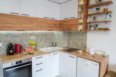 a kitchen with white cabinets and a sink at Central Cosy, Fully Renovated 2BD Near the Cathedral in Varna City