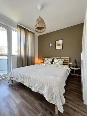 a bedroom with a large bed and a large window at Central Cosy, Fully Renovated 2BD Near the Cathedral in Varna City