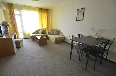a living room with a table and a couch at Evridika Apartments in Nesebar
