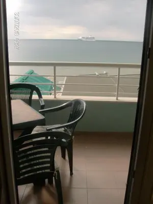 a balcony with a table and chairs and a view of the ocean at Evridika Apartments in Nesebar