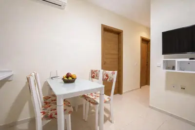 a white table and chairs with a bowl of fruit on it at Nice family apartment in Sunny Beach