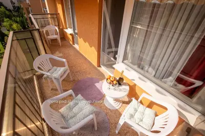 a balcony with chairs and a table on a balcony at Nice family apartment in Sunny Beach