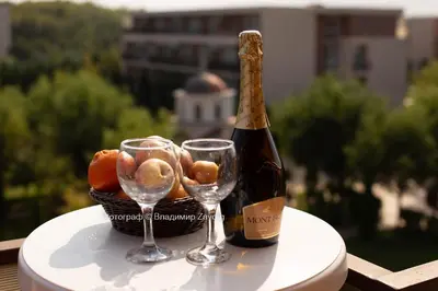 a bottle of champagne and two wine glasses on a table at Nice family apartment in Sunny Beach