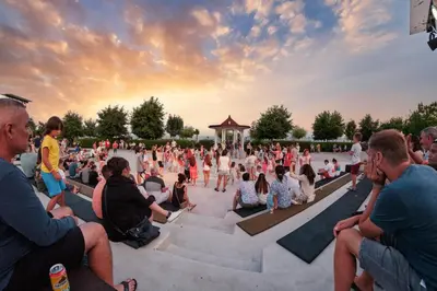 a crowd of people sitting in a amphitheater at sunset at Premier Fort Beach Hotel in Sveti Vlas