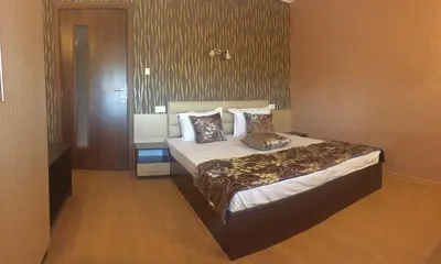 a bedroom with a bed with pillows on it at Dimitur Jekov Guest House in Obzor