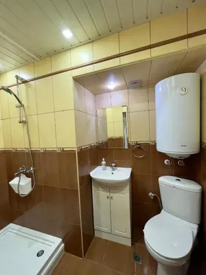 a bathroom with a toilet and a sink at Vi Del Mar Apartments Varna in Varna City